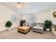 Inviting living room with plush gray sectional, ottoman, and large windows allowing for ample natural light at 5114 Mascaro Dr, Las Vegas, NV 89122