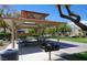 Covered picnic area with charcoal grill and tables provides a great place to socialize with neighbors at 7633 Tender Tassels St, Las Vegas, NV 89149