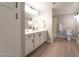 Bathroom with dual vanity, framed mirror, tile floors, and plenty of cabinet space at 8101 W Flamingo Rd # 2059, Las Vegas, NV 89147