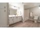 Bathroom with dual vanity, framed mirror, tile floors, and plenty of cabinet space at 8101 W Flamingo Rd # 2059, Las Vegas, NV 89147