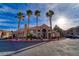 View of the community clubhouse featuring palm trees and covered entry at 8101 W Flamingo Rd # 2059, Las Vegas, NV 89147