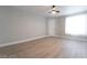 Open-concept room featuring laminated floors, neutral walls, contemporary fan, and lots of natural light at 8101 W Flamingo Rd # 2059, Las Vegas, NV 89147