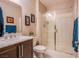 Well-lit bathroom featuring a glass-enclosed shower, a vanity with sink, and neutral tiling at 8303 Saddleback Ledge Ave, Las Vegas, NV 89147
