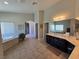 Bright bathroom features a soaking tub, a tile floor, and a double sink vanity at 8303 Saddleback Ledge Ave, Las Vegas, NV 89147