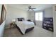 Cozy bedroom with neutral tones, soft carpet, ceiling fan, and a window for natural light at 8303 Saddleback Ledge Ave, Las Vegas, NV 89147