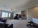 Spacious bonus room featuring carpet, a ceiling fan, large windows and a sitting area at 8303 Saddleback Ledge Ave, Las Vegas, NV 89147