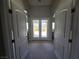 Arched doorway leading to backyard access provides natural light throughout the spacious entryway with carpet flooring at 8303 Saddleback Ledge Ave, Las Vegas, NV 89147