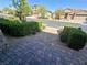 Paver walkway to the street with well-maintained landscaping and manicured bushes at 8303 Saddleback Ledge Ave, Las Vegas, NV 89147