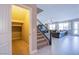 Hallway featuring storage closet, staircase, and views into the adjacent living area at 8303 Saddleback Ledge Ave, Las Vegas, NV 89147