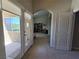 View of hallway with an arched entryway leading to a sitting area with natural light from the patio at 8303 Saddleback Ledge Ave, Las Vegas, NV 89147