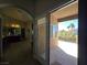 Open the sliding door to a balcony with desert trees and mountain views and a bathroom to the left at 8303 Saddleback Ledge Ave, Las Vegas, NV 89147