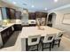 Open kitchen with large island, dark wood cabinets, white countertops, and stainless steel appliances at 8303 Saddleback Ledge Ave, Las Vegas, NV 89147