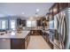 Modern kitchen with dark cabinets, stainless steel appliances, and a large island at 8303 Saddleback Ledge Ave, Las Vegas, NV 89147