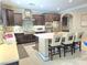 Bright kitchen with white countertops, dark cabinetry, stainless appliances, and center island with seating at 8303 Saddleback Ledge Ave, Las Vegas, NV 89147