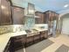 Well-equipped kitchen with stainless steel appliances, mosaic tile backsplash, and dark wood cabinetry at 8303 Saddleback Ledge Ave, Las Vegas, NV 89147