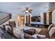 Modern living room showcasing a stone accent wall with a large television and plush furniture, plus wooden accents at 8303 Saddleback Ledge Ave, Las Vegas, NV 89147
