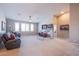 Spacious living room featuring large windows, a ceiling fan, and comfortable seating arrangements at 8303 Saddleback Ledge Ave, Las Vegas, NV 89147