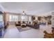Expansive living area with tile floors and open layout, connecting to kitchen and dining at 8303 Saddleback Ledge Ave, Las Vegas, NV 89147
