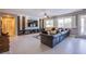Open-concept living area with a large entertainment center and tile flooring at 8303 Saddleback Ledge Ave, Las Vegas, NV 89147