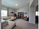 Spacious living room features a comfortable sectional sofa, bookshelves, and views of the outside at 8303 Saddleback Ledge Ave, Las Vegas, NV 89147