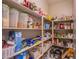 Walk-in pantry with ample shelving, stocked with various food items and storage containers for optimal organization at 8303 Saddleback Ledge Ave, Las Vegas, NV 89147