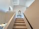 Bright staircase leading to the second floor, featuring neutral colors and an ornate console table at 8303 Saddleback Ledge Ave, Las Vegas, NV 89147