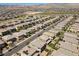Beautiful aerial view of a desert community with many homes, desert landscaping, and mountain views at 888 Cherry Glen Pl, Las Vegas, NV 89138