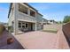Spacious backyard featuring a brick patio, a small table set, and a well-maintained artificial grass area at 888 Cherry Glen Pl, Las Vegas, NV 89138
