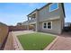 Backyard with a putting green, brick-lined edges, and a cozy patio area with an outdoor table at 888 Cherry Glen Pl, Las Vegas, NV 89138