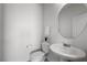 Well-lit powder room with a pedestal sink, modern fixtures, and a clean, minimalist design at 888 Cherry Glen Pl, Las Vegas, NV 89138