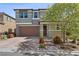 Charming two-story home with a brick driveway, attached two-car garage, and professionally landscaped yard at 888 Cherry Glen Pl, Las Vegas, NV 89138
