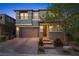 Exterior view of a home with brick driveway, attached two-car garage, manicured yard, and covered front porch at 888 Cherry Glen Pl, Las Vegas, NV 89138