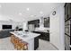 Open concept kitchen with stainless appliances, central island with seating, and dark wood cabinets at 888 Cherry Glen Pl, Las Vegas, NV 89138
