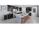 Modern kitchen with stainless steel appliances, island with bar stools, and dark wood cabinetry at 888 Cherry Glen Pl, Las Vegas, NV 89138