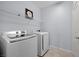 Efficient laundry room with modern washer and dryer and a practical wire shelf at 888 Cherry Glen Pl, Las Vegas, NV 89138