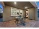 Covered patio with a brick floor, glass-top table and an entrance with a glass door at 888 Cherry Glen Pl, Las Vegas, NV 89138