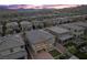 A beautiful gray home with a small balcony and patio with seating, lush turf, and mountains in the background at 888 Cherry Glen Pl, Las Vegas, NV 89138