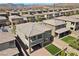 View of a gray stucco home with a balcony and a brick patio with turf and mountain views in a desert community at 888 Cherry Glen Pl, Las Vegas, NV 89138