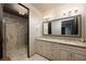 Bright bathroom boasts a double vanity, a large decorative mirror, and a glass-enclosed shower at 1123 Christian Rd, Henderson, NV 89002