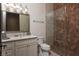 Bathroom with white cabinets, granite countertop, and a glass shower with decorative tile at 1123 Christian Rd, Henderson, NV 89002
