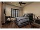 A stylish bedroom with dark wood floors, a cozy chair and tufted headboard at 1123 Christian Rd, Henderson, NV 89002