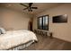 Cozy bedroom with a queen-sized bed, a large window with shutter blinds, and a modern ceiling fan at 1123 Christian Rd, Henderson, NV 89002
