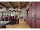 Open dining room with a long table and leather chairs, alongside built-in cabinets and beautiful archways at 1123 Christian Rd, Henderson, NV 89002