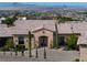 Front elevation of a home featuring a stone facade and desert landscaping at 1123 Christian Rd, Henderson, NV 89002