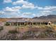 Desert home with a stone wall, tiled roof, and beautiful landscape at 1123 Christian Rd, Henderson, NV 89002