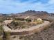 Expansive hillside property with winding driveway, desert landscaping, and panoramic mountain views at 1123 Christian Rd, Henderson, NV 89002