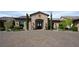 Elegant stone-accented entrance with a paved driveway and landscaped greenery, creating a welcoming approach at 1123 Christian Rd, Henderson, NV 89002