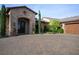 Charming stone home with arched entry, manicured landscaping, and a spacious brick driveway at 1123 Christian Rd, Henderson, NV 89002