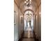 Elegant hallway with arched ceilings, stone floors, recessed lighting and decorative chandeliers at 1123 Christian Rd, Henderson, NV 89002