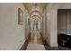Long hallway with arched ceilings, beautiful chandeliers, and travertine floors at 1123 Christian Rd, Henderson, NV 89002